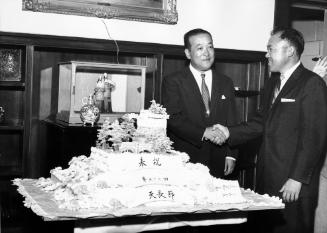 [George Izumi presents cake to Japanese Consul General Shigeru Nakamura for Tenchosetsu, the Emperor's birthday, Los Angeles, California, April 29, 1958]