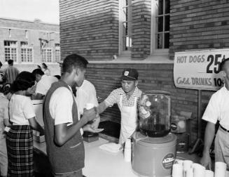 [PTA fathers work concession stand at Milk Bowl football game at Los Angeles High School, Los Angeles, California, October 17, 1958]