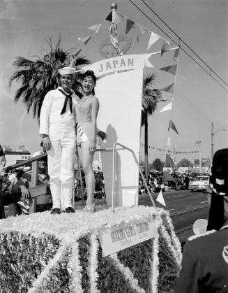 [Miss Japan with sailor on Miss Universe parade float, Long Beach, California, July 20, 1958]