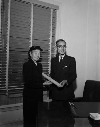 [Mrs. Tameji Eto receives Kunsho on behalf of her late husband at Japanese Consulate General's office, Los Angeles, California, January 8, 1959]