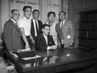 [Joint Nisei Trojan-Nisei Bruin donation to Japanese American Youth, Inc. at Kenji Ito's office, California, January 16, 1959]