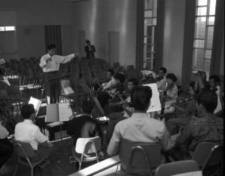 [Conductor Akira Kikukawa and Japanese American Orchestra rehearsal at St. Mary's Church, Los Angeles, California, April 1961]