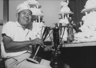 [George Izumi of Grace Pastries Shoppe with trophies, Los Angeles, California, October 30, 1963]