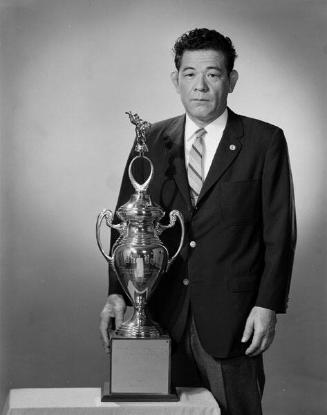 [Kaname Kuniyuki with Nozawa Boeki Judo trophy, California, April 10, 1965]