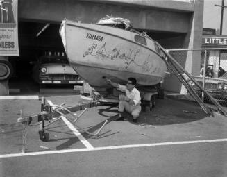 [Ikuo Kawashima with sloop, "Koraasa", at Little Tokyo Parking, Los Angeles, California, February 19, 1966]