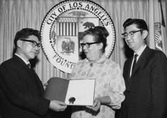 [Takefumi Komatsu receiving official greetings from Mrs. Eleanor Chambers and George Saiki at Los Angeles City Hall, Los Angeles, California, April 30, 1966]
