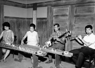 [Koto players, Shinichi Yuize and Yasuko Nakashima, preparing for Budo-Kai Japanese music concert at Mrs. Kyoko Wakita's home, California, August 28, 1966]