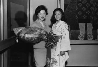 [Actress Yoshiko Sakuma and Mr. Okawa, President of Toei Movie Company at airport, Los Angeles, California, July 10, 1968]