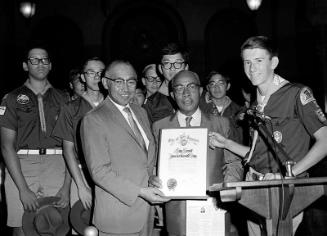 [Los Angeles City Councilman Gilbert Lindsay presenting "Boy Scout International Day" proclamation to Boy Scouts, Los Angeles, California, July 28, 1970]