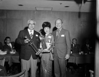 [Datsun Motors and the Miyoko Komori dancers receiving Santa Claus Lane trophies from Hollywood Chamber of Commerce at Imperial Dragon, Los Angeles, California, December 6, 1970]
