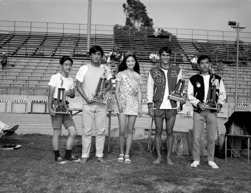 [Four athletes and girl in tiara and sash, California, 1970]