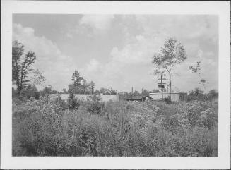 [Water tank and buildings across field, Rohwer, Arkansas, 1942-1945]