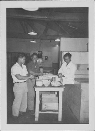 [Three men prepare rice balls in mess hall kitchen, Rohwer, Arkansas, 1942-1945]