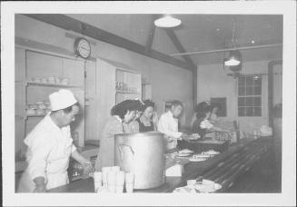 [Men and women preparing plates of food in mess hall, Rohwer, Arkansas, 1942-1945]