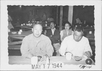 [Two men eating in mess hall, Rohwer, Arkansas, May 17, 1944]