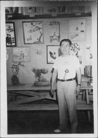 [Man in front of bonsai and artwork, Rohwer, Arkansas, July 22, 1945]