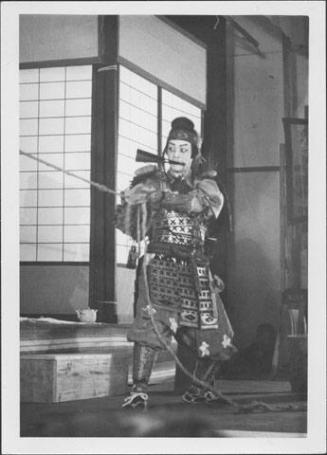 [Warrior with fan in mouth and holding rope in Kabuki play, Rohwer, Arkansas]