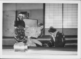 [Couple bending over child in Kabuki play, Rohwer, Arkansas, November 12, 1944]
