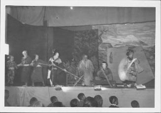[Cast pulling boat while woman paddles in Kabuki play, Rohwer, Arkansas]